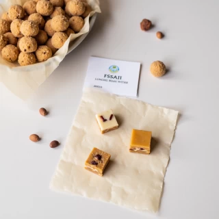 Flat-lay of mithai with visible FSSAI label card.